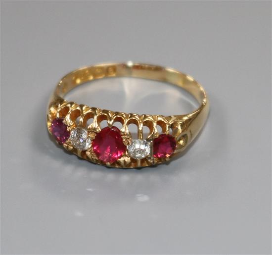 An Edwardian 18ct gold five stone ruby and diamond half hoop ring, size R.